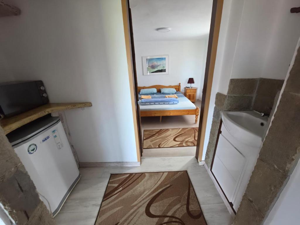 a small bathroom with a bed and a sink at Sinemoria apartment in Sinemorets
