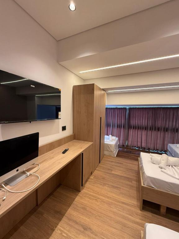 a room with a bed and a tv in a room at Fabrika in Vlorë