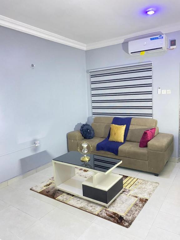 a living room with a couch and a coffee table at Legacy apartments in Ikeja