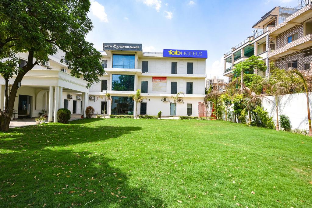 an empty lawn in front of a building at FabHotel Rajvanshi Palace in Gumgaon