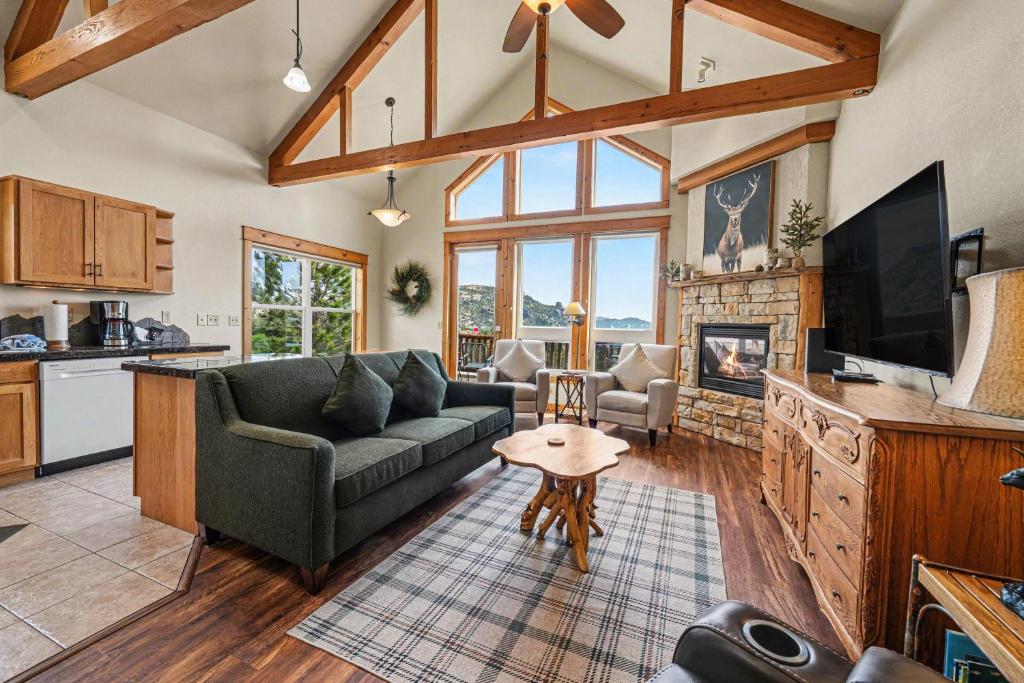 a living room with a couch and a tv at Jackstraw Mountain 32 in Estes Park