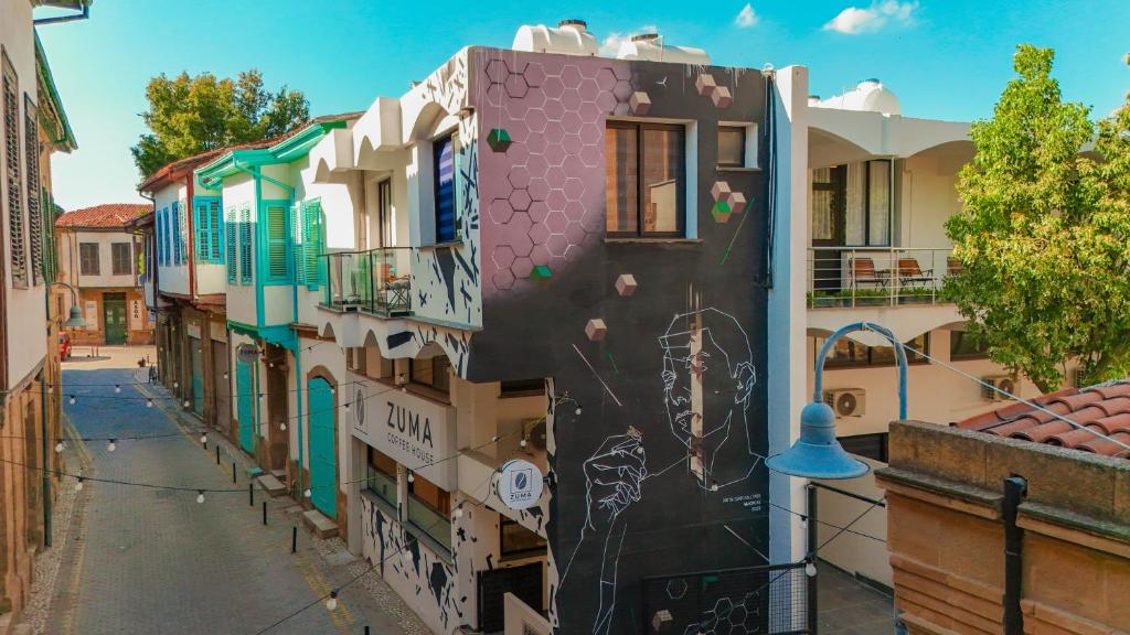 a building with graffiti on it on a street at Zuma Hotel Cyprus - Turkish Side in Nicosia