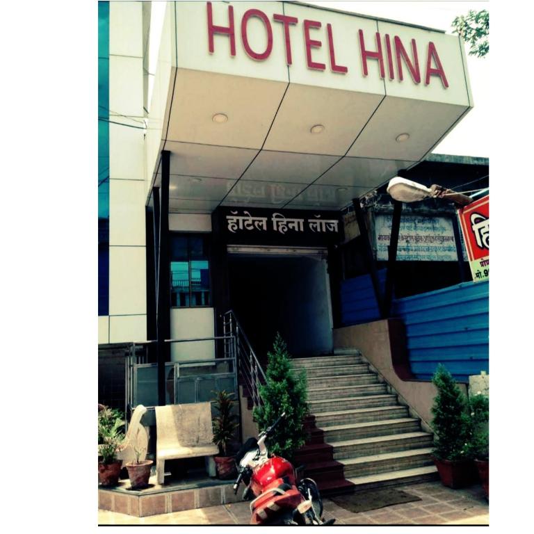 a dog sitting on a motorcycle in front of a hotel at Hotel heena in Bīr