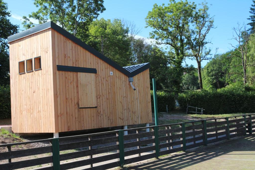 a small wooden building on a fence at Eco-Bivouac in La Tagnière
