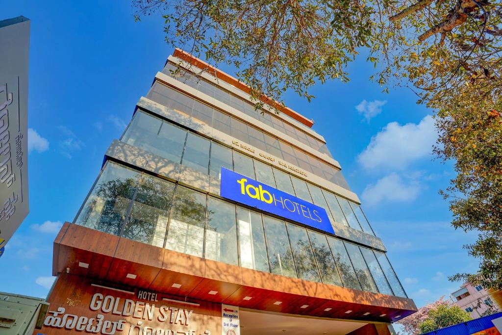 a building with a colgate hotel sign on it at FabHotel Golden Stay I in Bangalore
