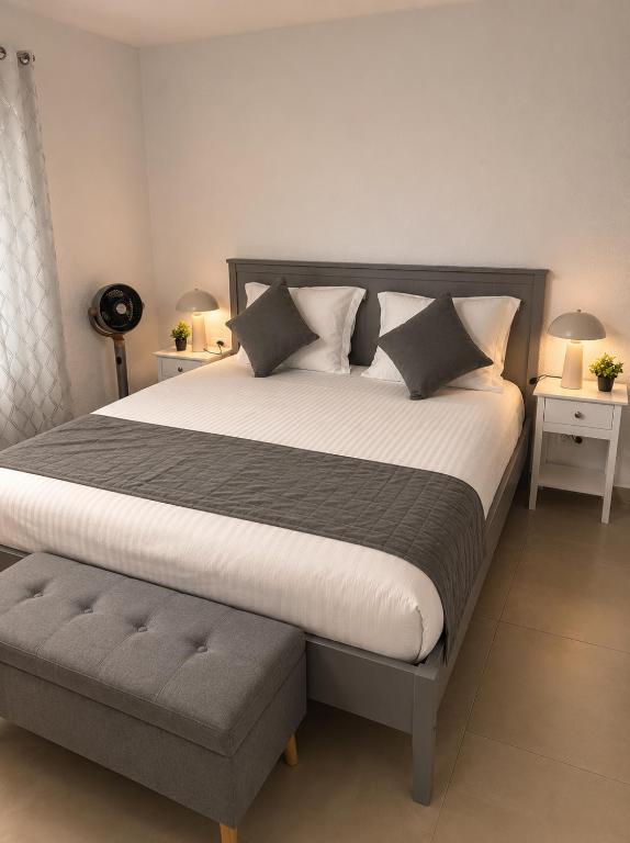 a bedroom with a large bed and two night stands at NEU! Fly & Stay Residence Frankfurt Airport Kelsterbach in Kelsterbach