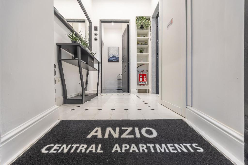 a hallway with anzio central apartments sign on the floor at Anzio Central Apartments in Anzio