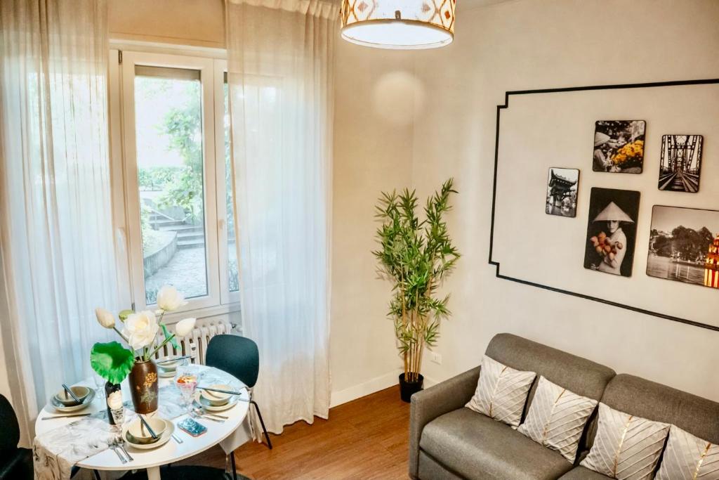 a living room with a table and a couch at Zen Suite - 50m from Metro M1 - Direct to F1 Monza, Fashion Week, Duomo in Milan
