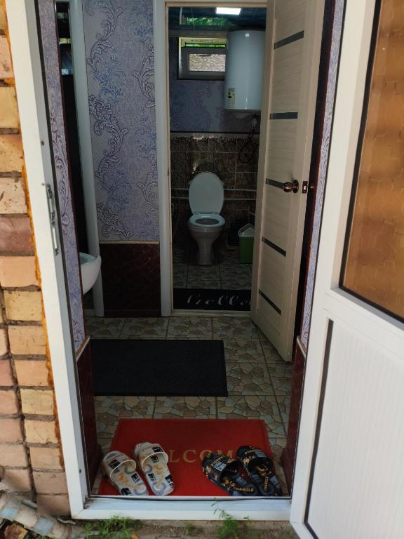 an open door to a bathroom with a toilet at Geust house Paradise in Arslanbob