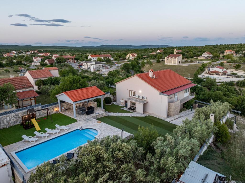 an aerial view of a villa with a swimming pool at Villa Elder ZadarVillas in Donji Lepuri