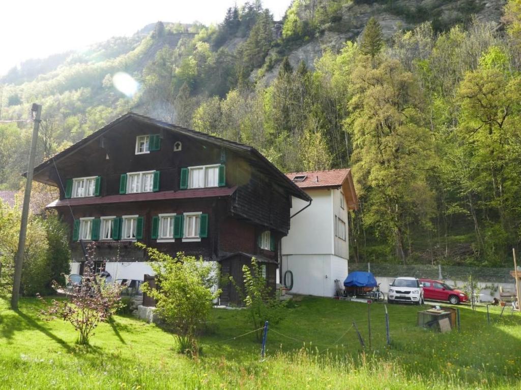 a large house in the middle of a field at Holiday Home by Interhome in Lungern