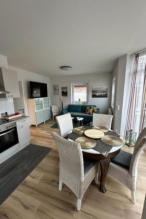 a kitchen and living room with a table and chairs at Apartment FEWO „Am Stausee“ by Interhome in Friesoythe