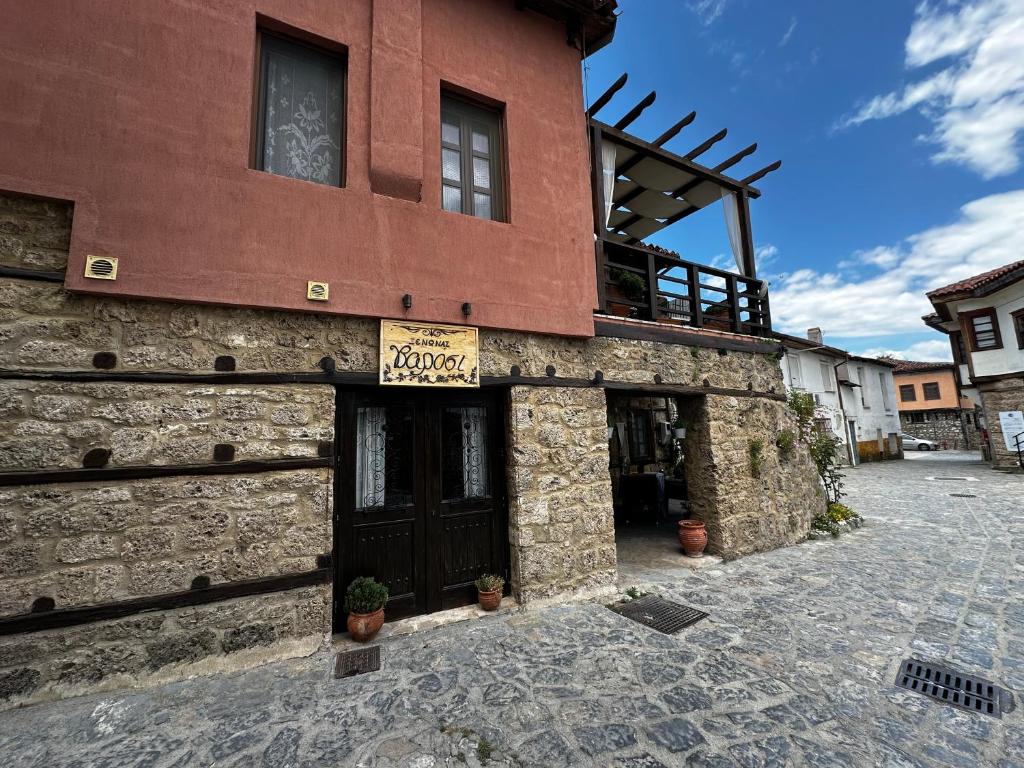 a large brick building with a sign on it at Varosi Guesthouse in Edessa