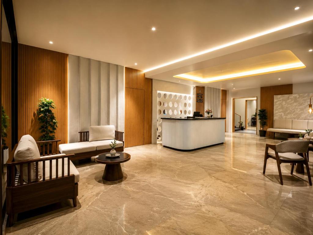 a lobby of a hotel with a reception desk at The Sapphire Hotel in Belgaum
