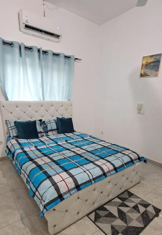 a bed in a room with a window at Chez Bryan in Avéméné