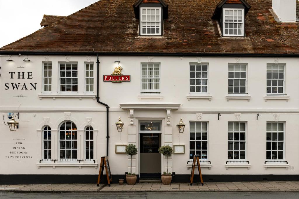 a white building with a sign that reads the swan at The Swan in Arundel