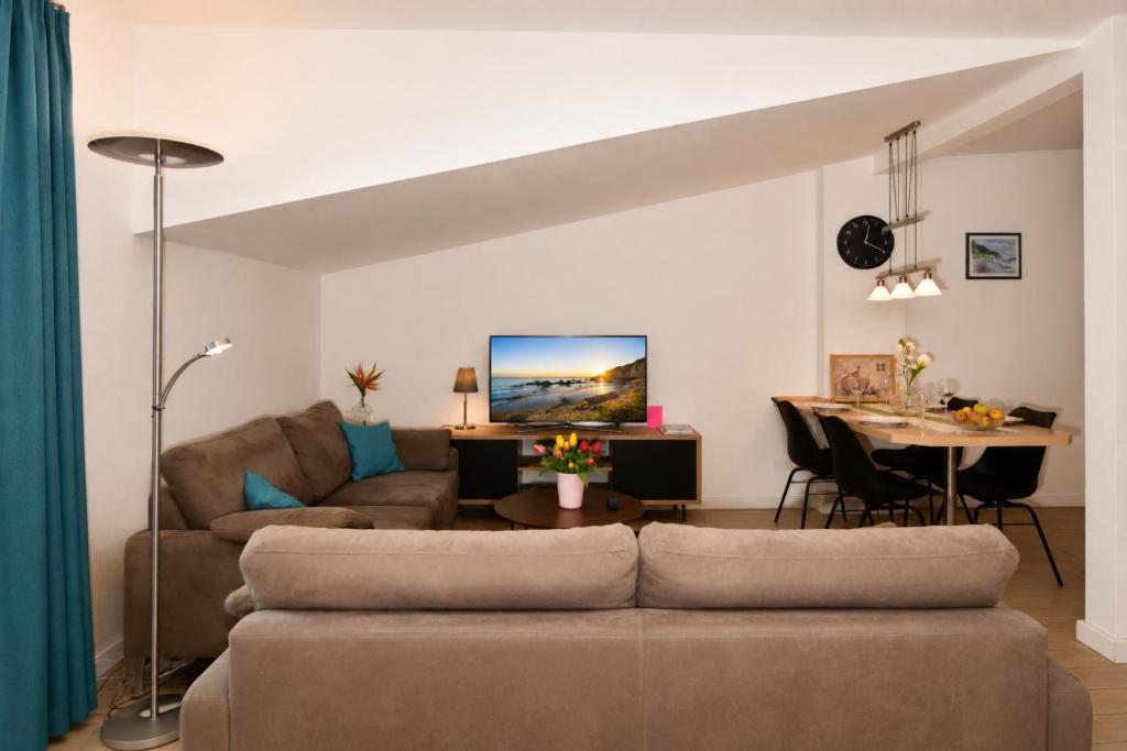 a living room with a couch and a table at Ferienhaus Alisch Fewo 2 in Warnemünde