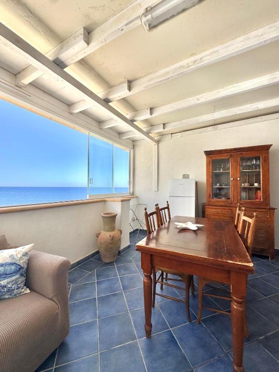 a living room with a table and a couch at Vivi Marettimo in Marettimo