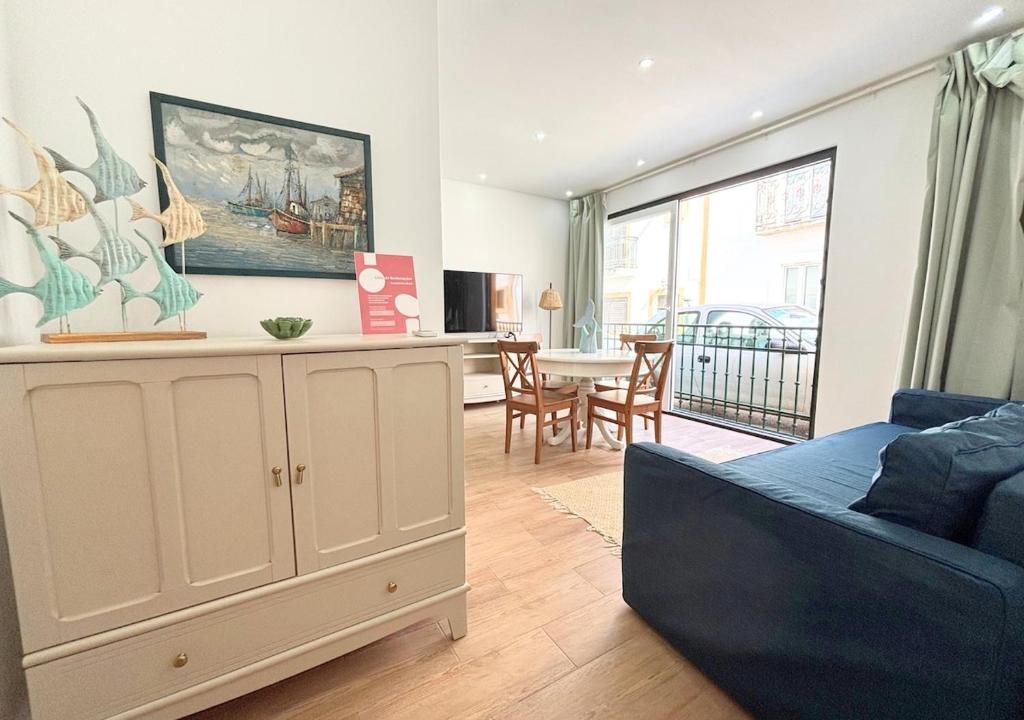 a living room with a couch and a dining room at Casa na Aldeia in Melides