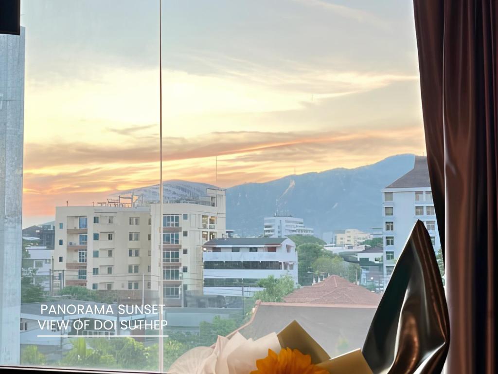 a view of a city from a window at The Hive Chiang Mai Hotel in Chiang Mai