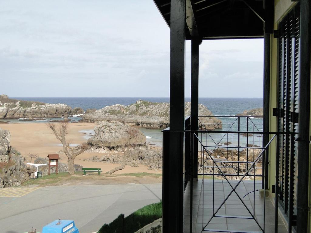 a view of the ocean from a balcony at Apartamentos El Pinedo in Noja