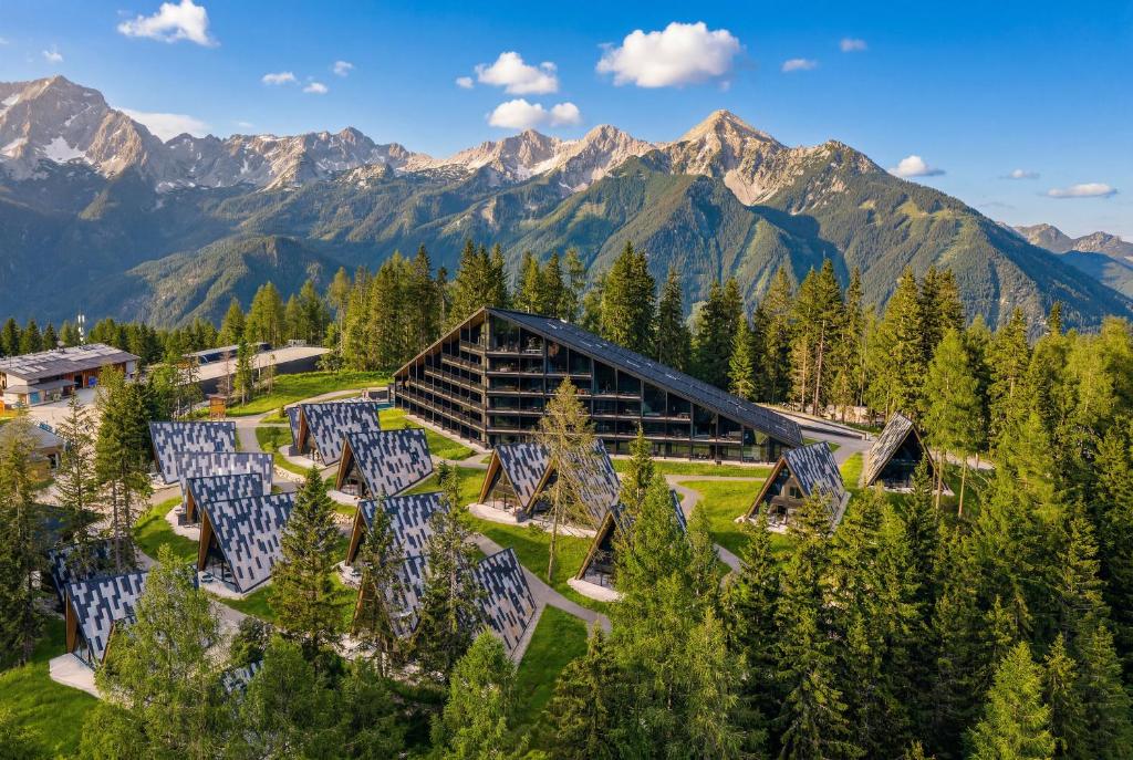 an aerial view of a lodge with mountains in the background at TRIFORET alpin resort by Falkensteiner in Hinterstoder