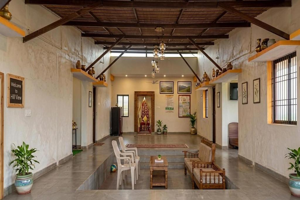 a large room with chairs and a table in it at Hills View Stay in Māvingundi