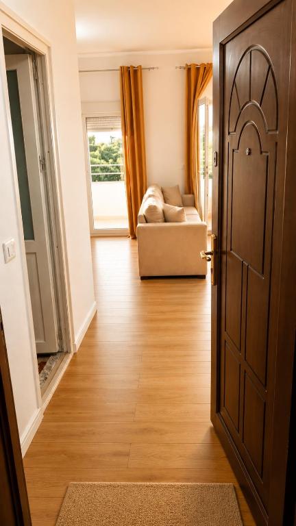 an open door to a living room with a couch at Sunset Terrace in Durrës