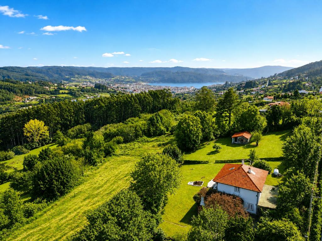 an aerial view of a house on a grassy hill at Airtegal Casa do Pepe Cedeira in Cedeira