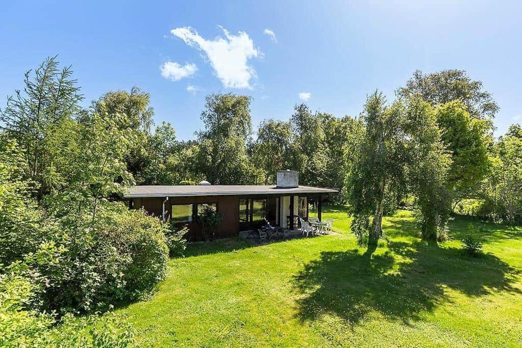 a house in the middle of a field with trees at 1007-N-Hundested-Humlehaven-5 in Hundested