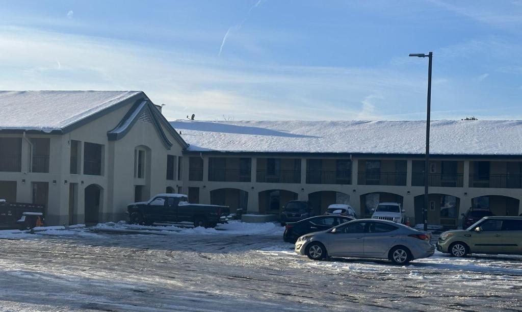 a building with cars parked in a parking lot at Red Roof Inn Media, PA in Media