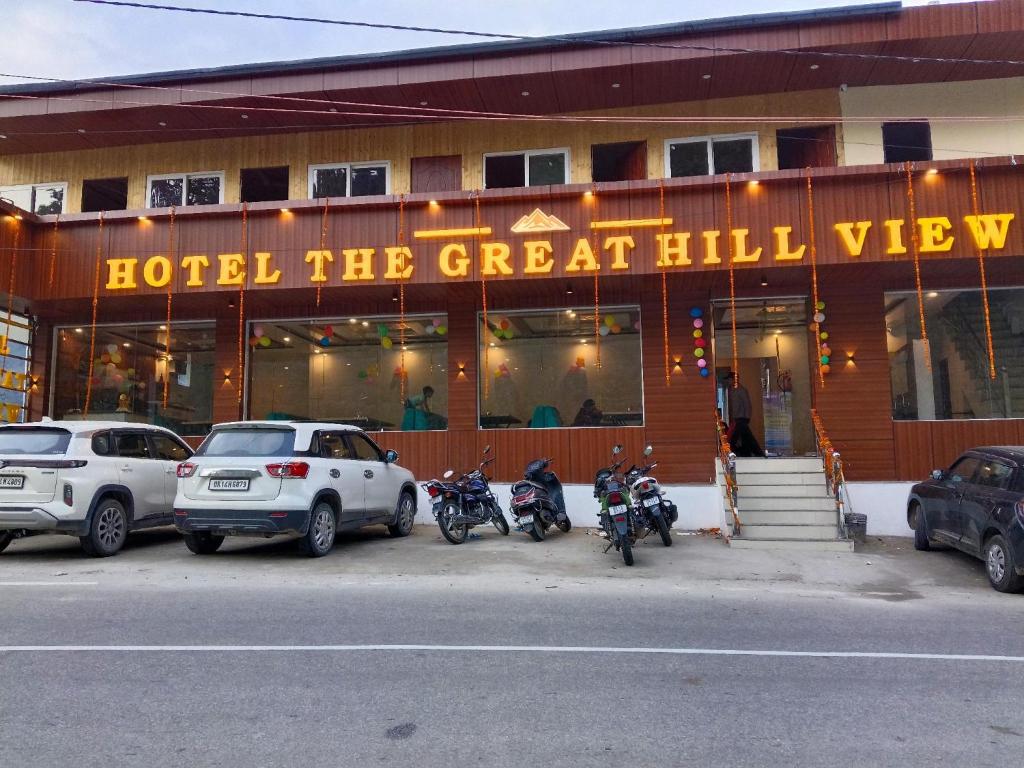 a hotel with motorcycles parked in front of a building at The Great Hill View Hotel in Phata