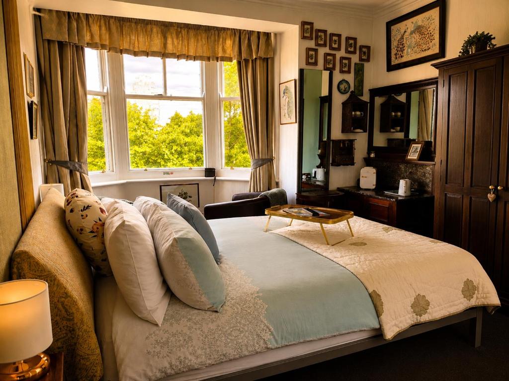 a bedroom with a bed with pillows and a window at The Ocean Guest House in Weymouth