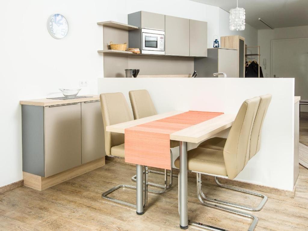a kitchen with a wooden table and chairs at Apart Peter in Seefeld in Tirol