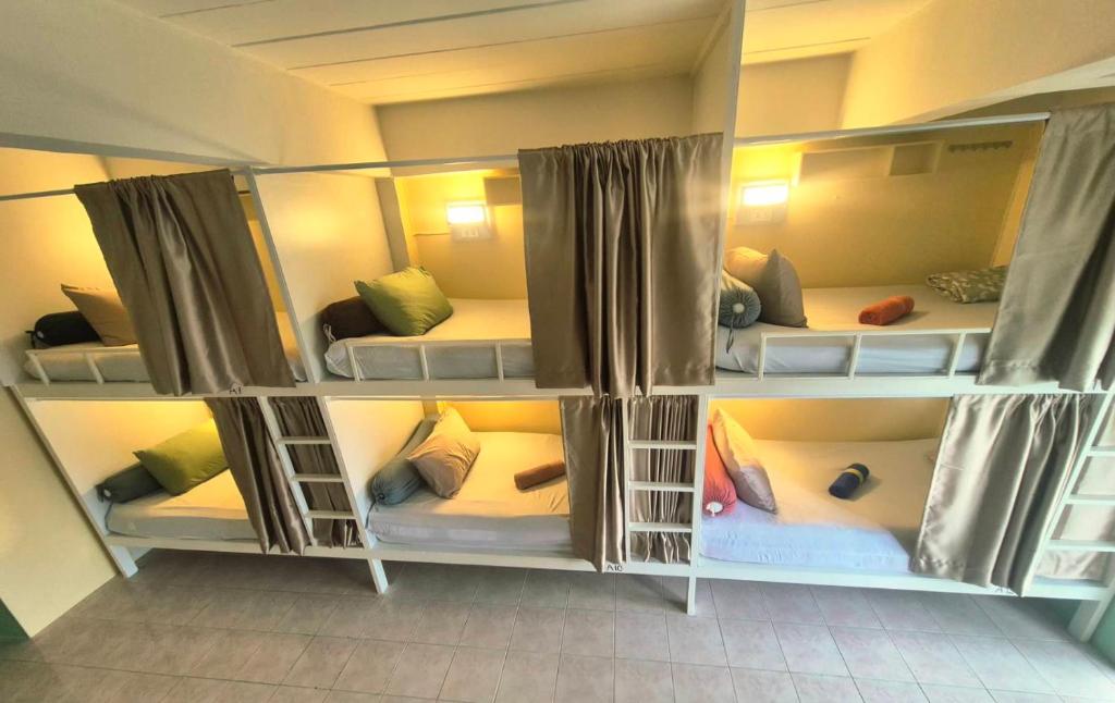 a room with four bunk beds in a room at DK1Hostel in Chaweng