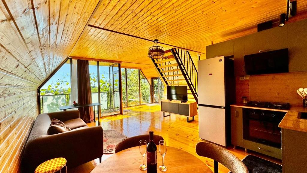 a living room with a couch and a refrigerator at Alamabari Inn in Kobuleti