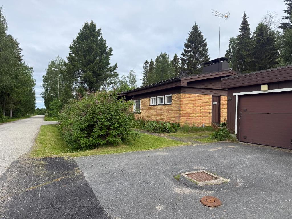 a brick house with a garage and a driveway at Dream Big House Tervaharju in Kemi