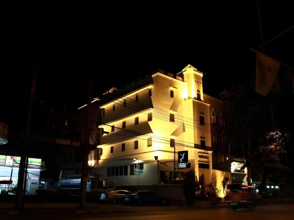 a lit up building at night with at JamPark City in Bangkok