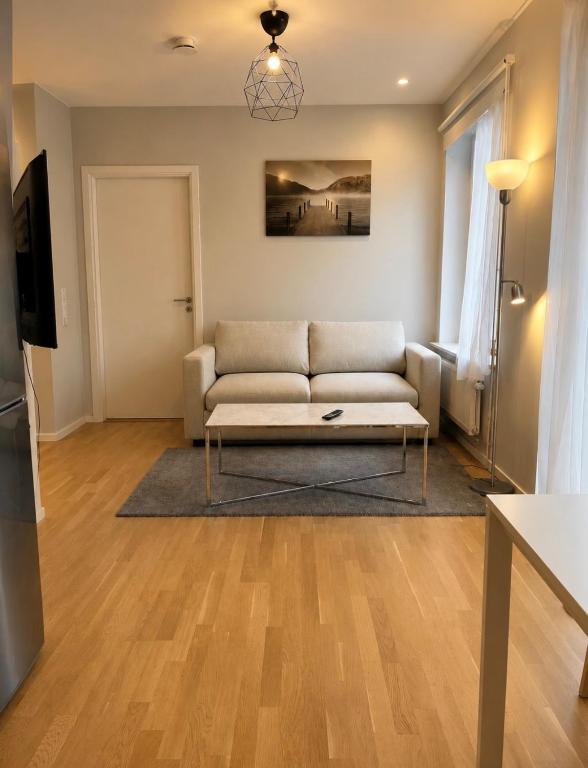 a living room with a couch and a table at Modern lägenhet i Vasastan in Stockholm