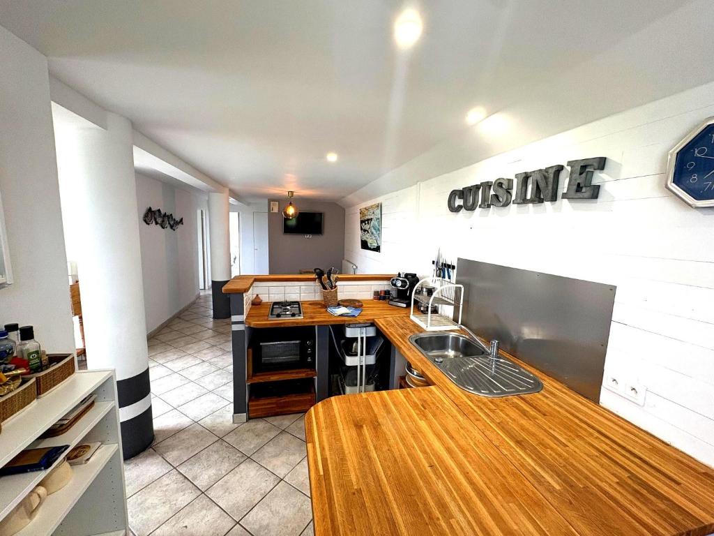 a kitchen with a sink and a counter top at Les Henrions in Pierrelatte