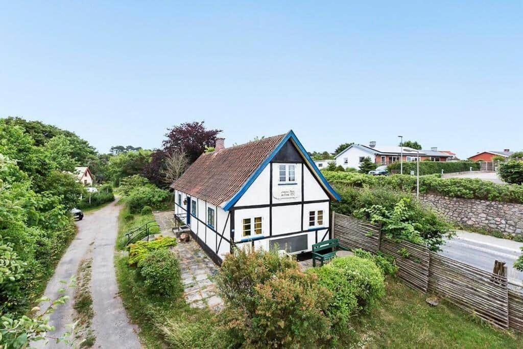 a white house with a blue roof and a road at 1102-N-Hundested-Skansevej-45 in Hundested