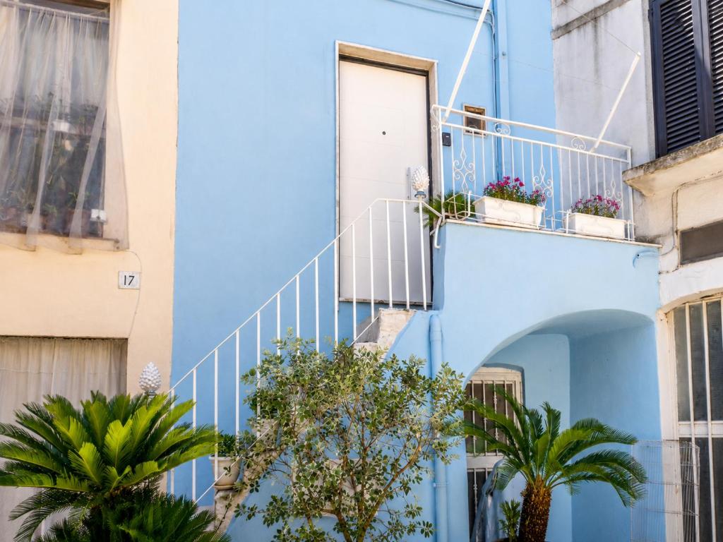 a blue building with stairs and plants on it at Rallenta Casamassima in Casamassima