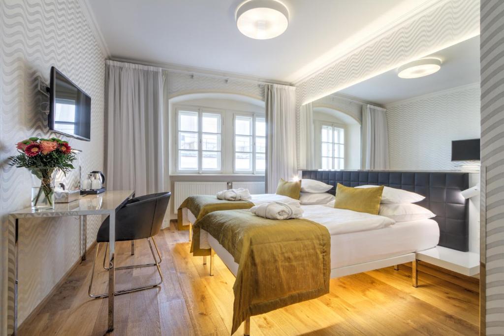 a bedroom with a bed and a desk in a room at Golden Star in Prague