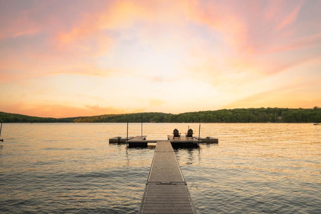 two people on a dock on a lake at sunset at Bear on the Lake in Oakland