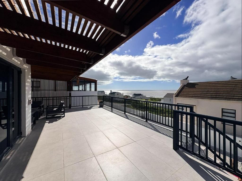 a balcony with a view of the ocean at Swordfish Retreat in St. Helena Bay