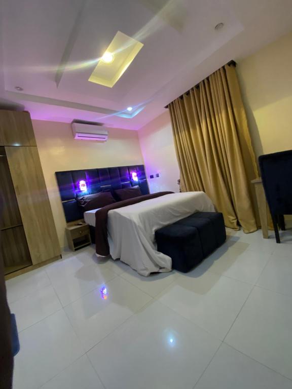 a bedroom with a bed with purple lights in it at Chase hotels in Ibadan