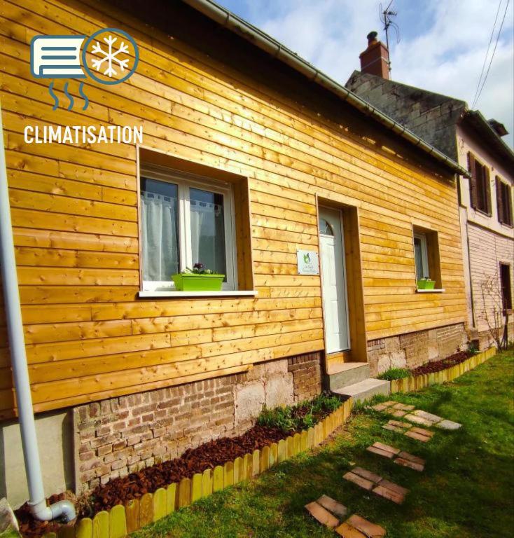 a wooden house with a sign on the side of it at Les Nuits Bonneuilloises Le Mustang in Bonneuil-les-Eaux