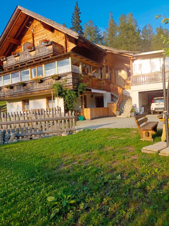 a large house with a fence in front of it at Fewo-Mirnig in Hochrindl