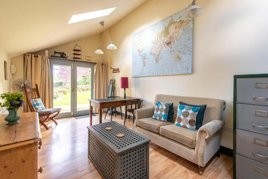 a living room with a couch and a table at The Forge, Snitterton near Matlock in Moffat