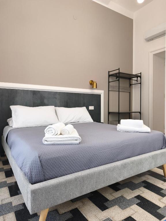 a bedroom with a bed with two towels on it at Palazzo San Giorgio 1924 in Scilla